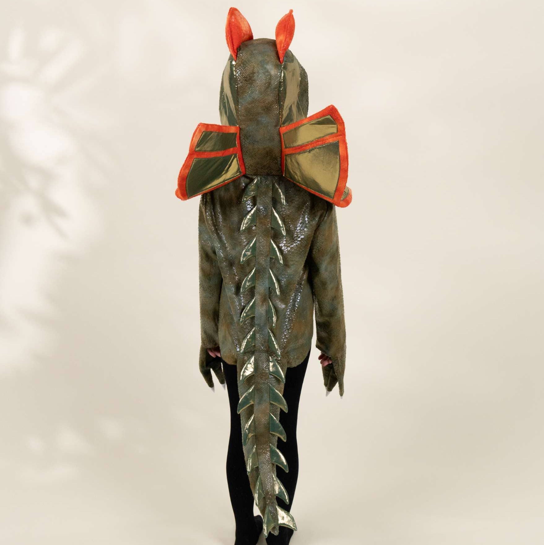 Green lizard costume with red bow and ears on a white background