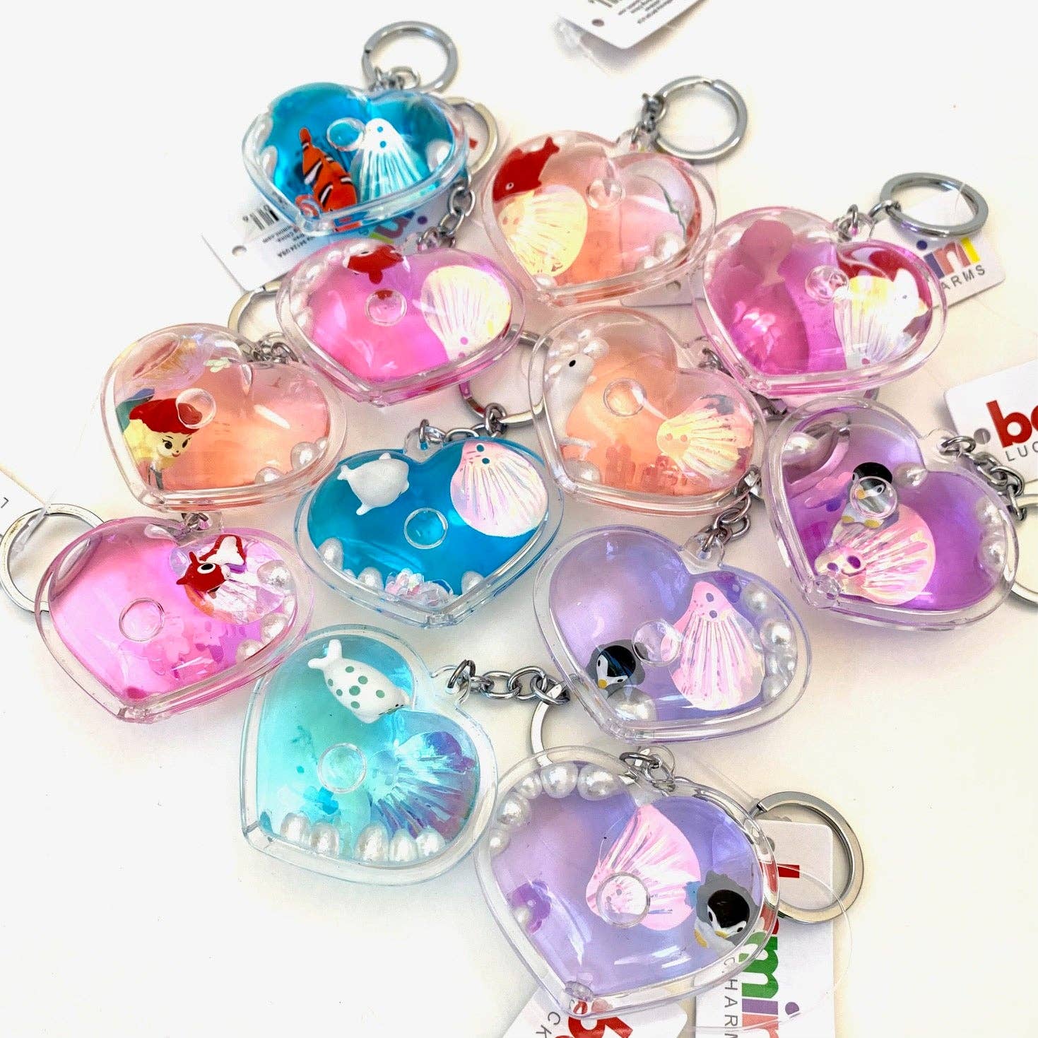 Heart-shaped keychains with various designs on a white background