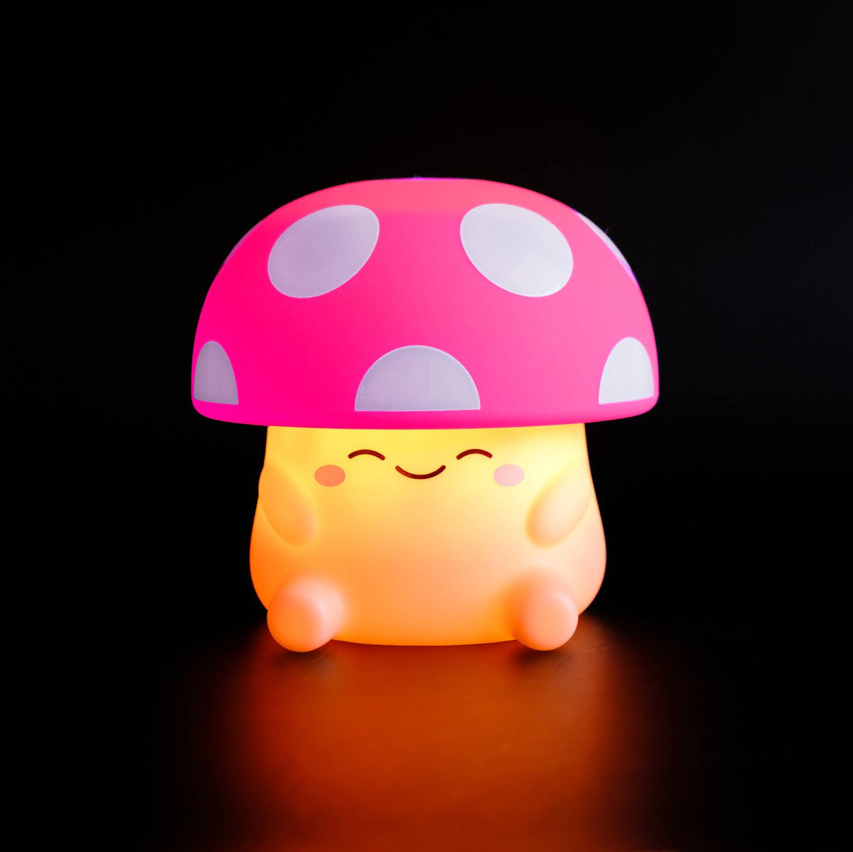 Mushroom-shaped night light with a pink cap and yellow body on a black background
