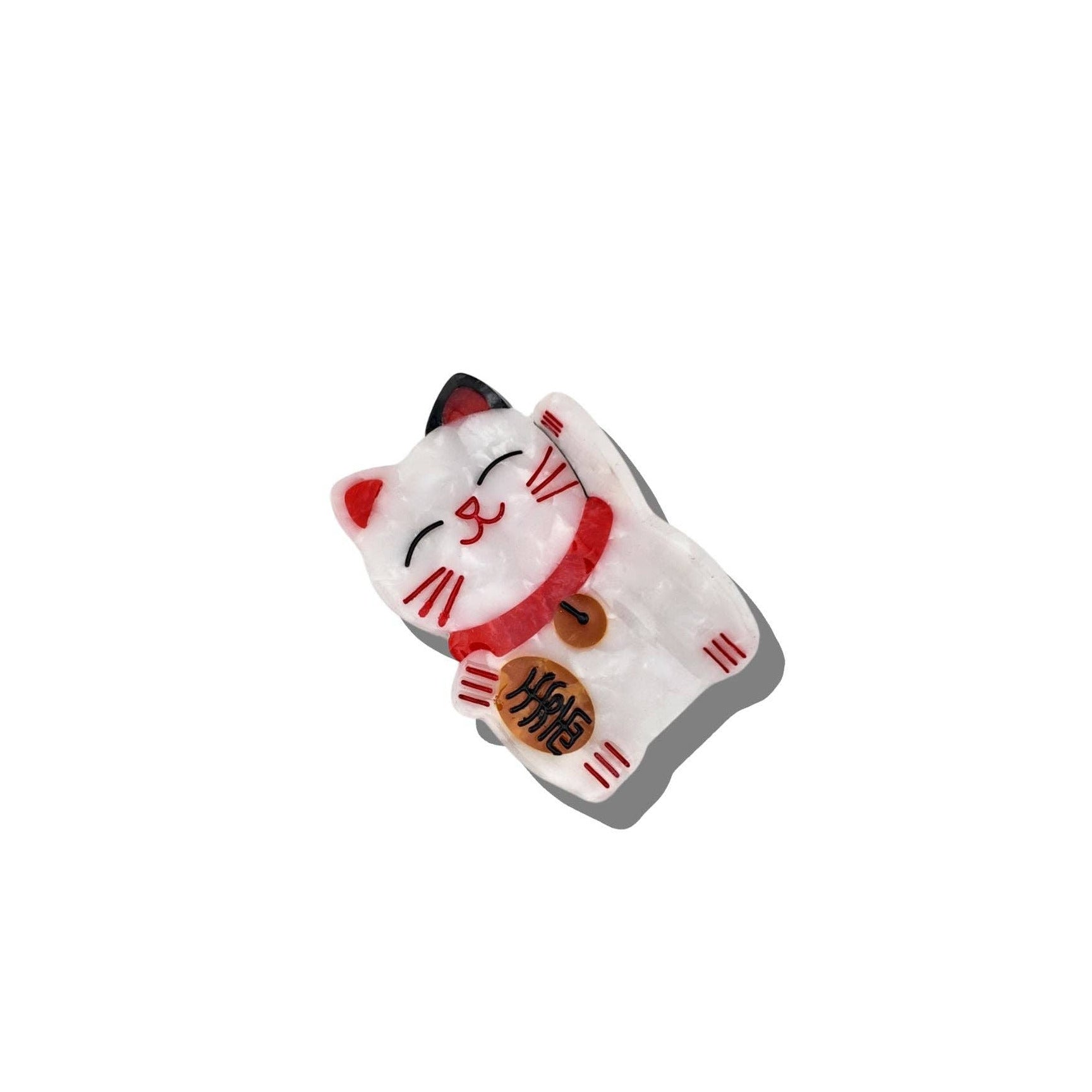 White cat-shaped container with red accents on a white background