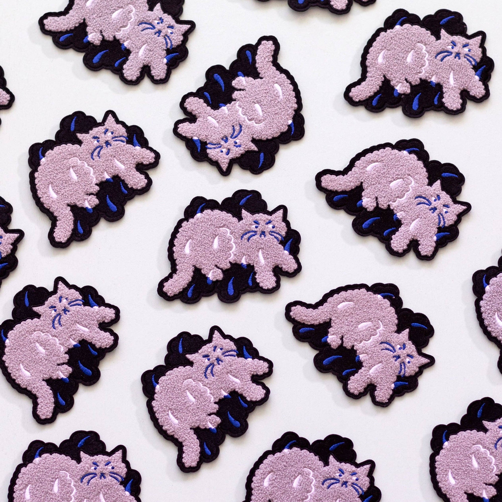 Pattern of pink cat-like creatures with black outlines on a white background