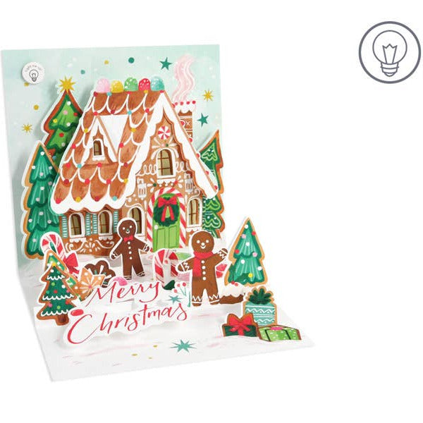 Gingerbread house Christmas card with decorative elements on a white background