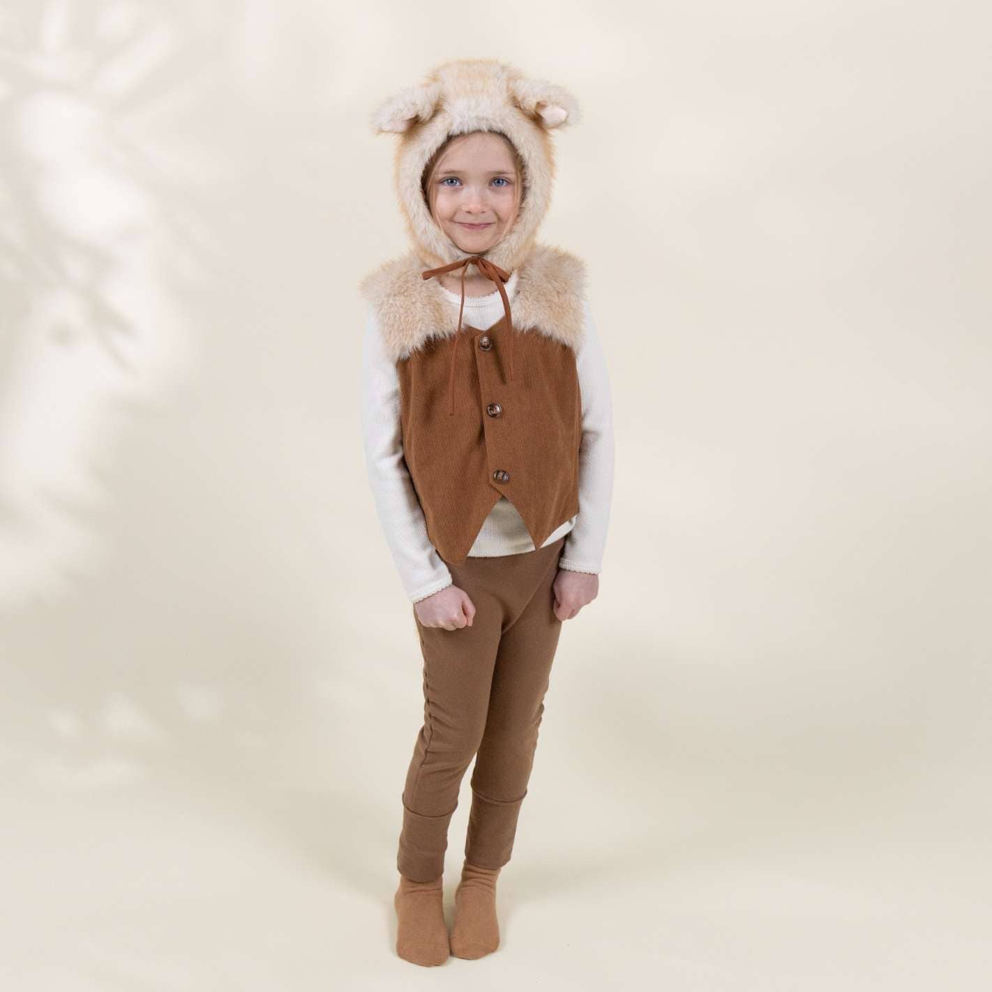 Child wearing a brown animal costume with a hood on a white background