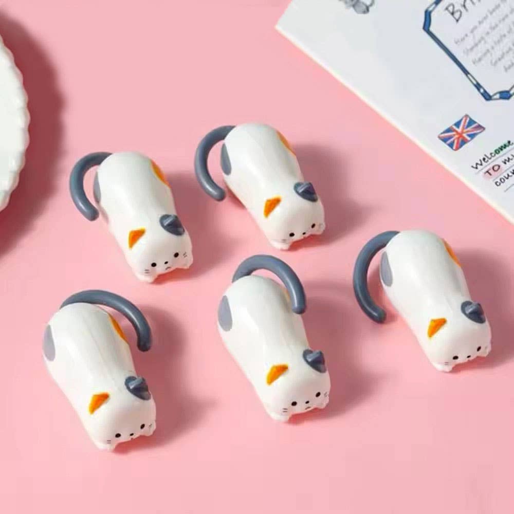 Cat-shaped toys on a pink background