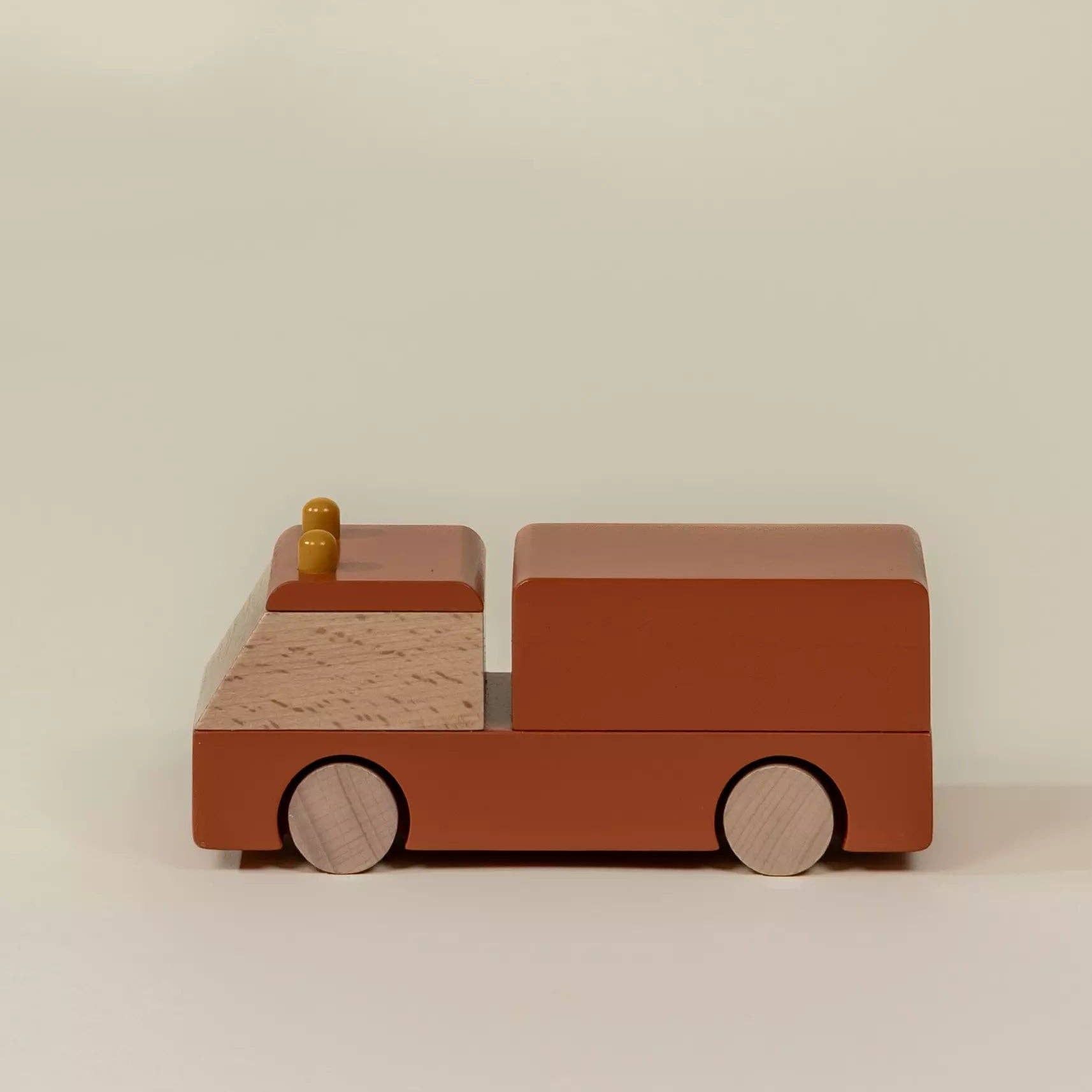 Wooden toy car on a beige background