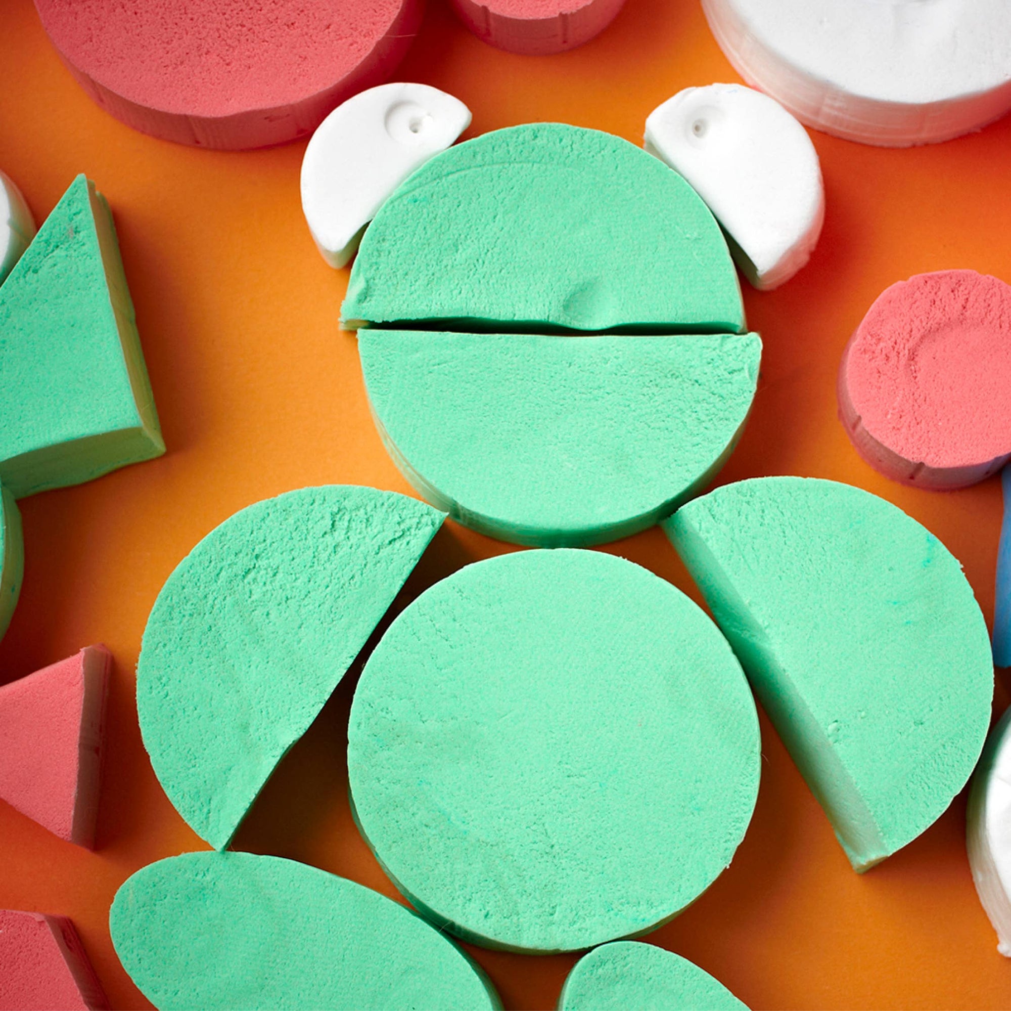 Colorful foam shapes on an orange background