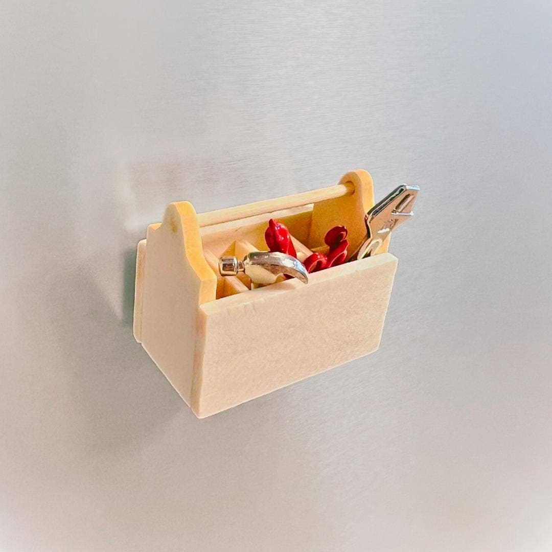 Wooden wall-mounted organizer with keys and a ring on a light gray background
