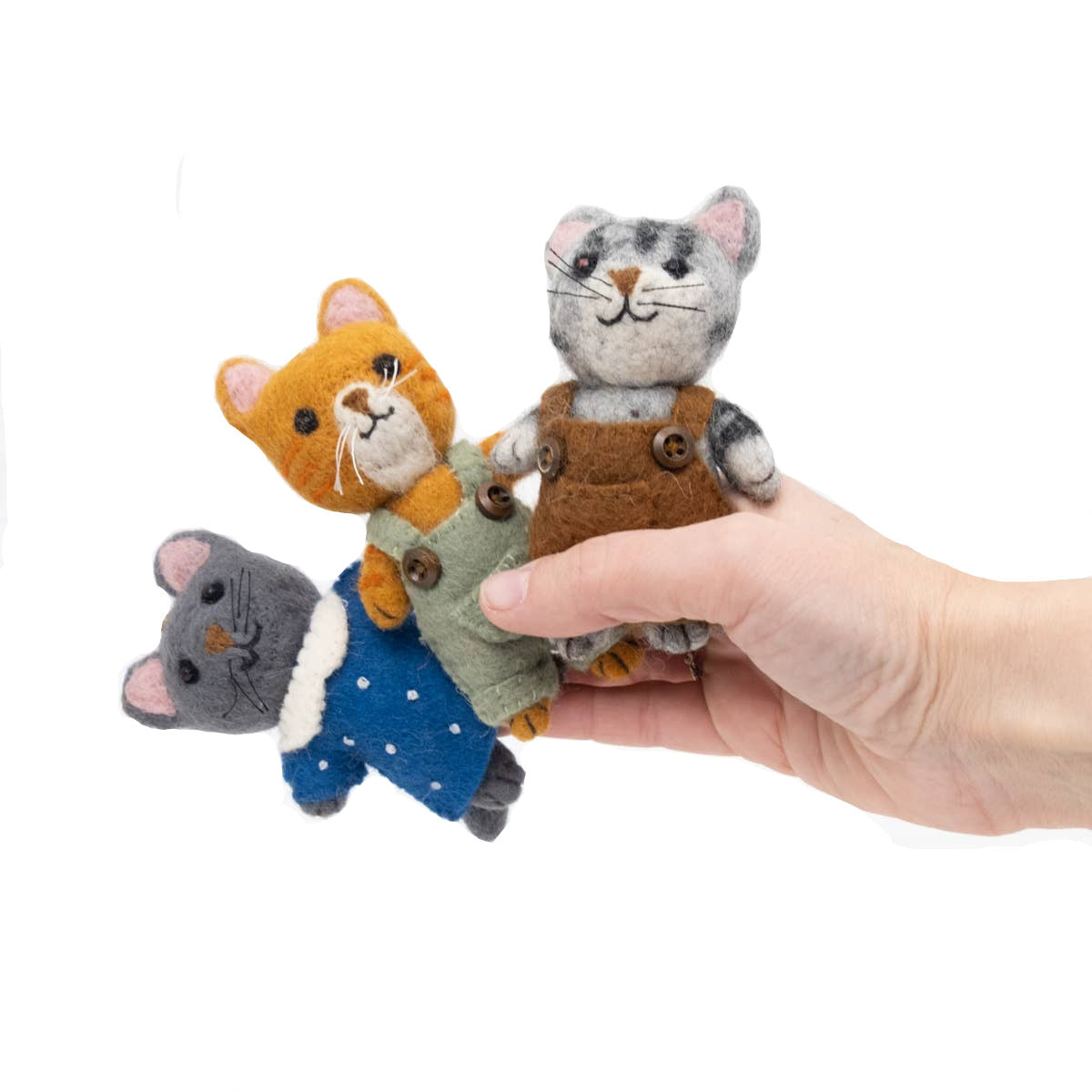 Hand holding three small felt animal toys on a white background