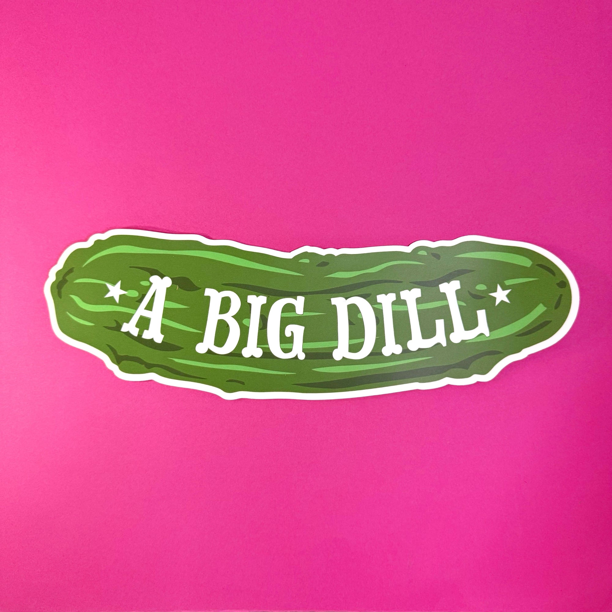 Green pickle-shaped sign with 'A BIG DILL' text on a pink background