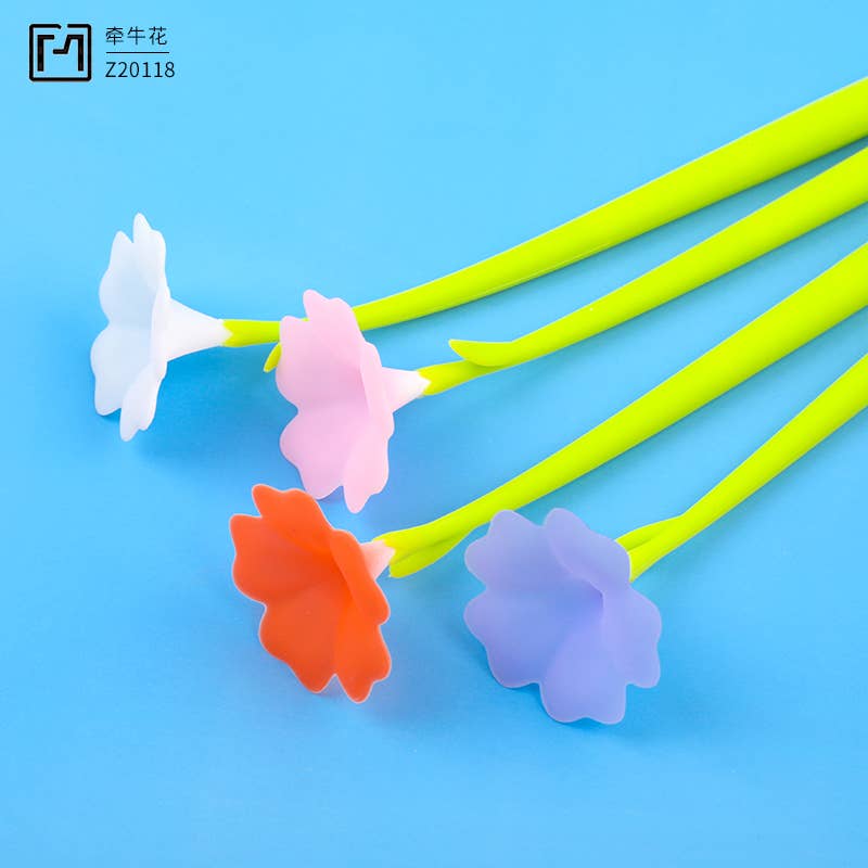 Colorful flower-shaped stir sticks on a blue background