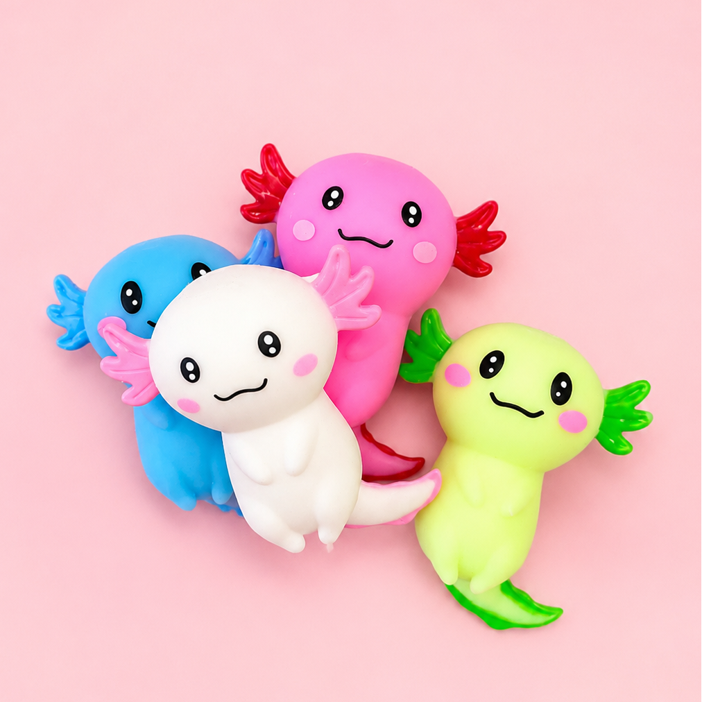 Four cute, cartoonish axolotl figurines in pink, blue, white, and green, arranged together on a solid light pink background.