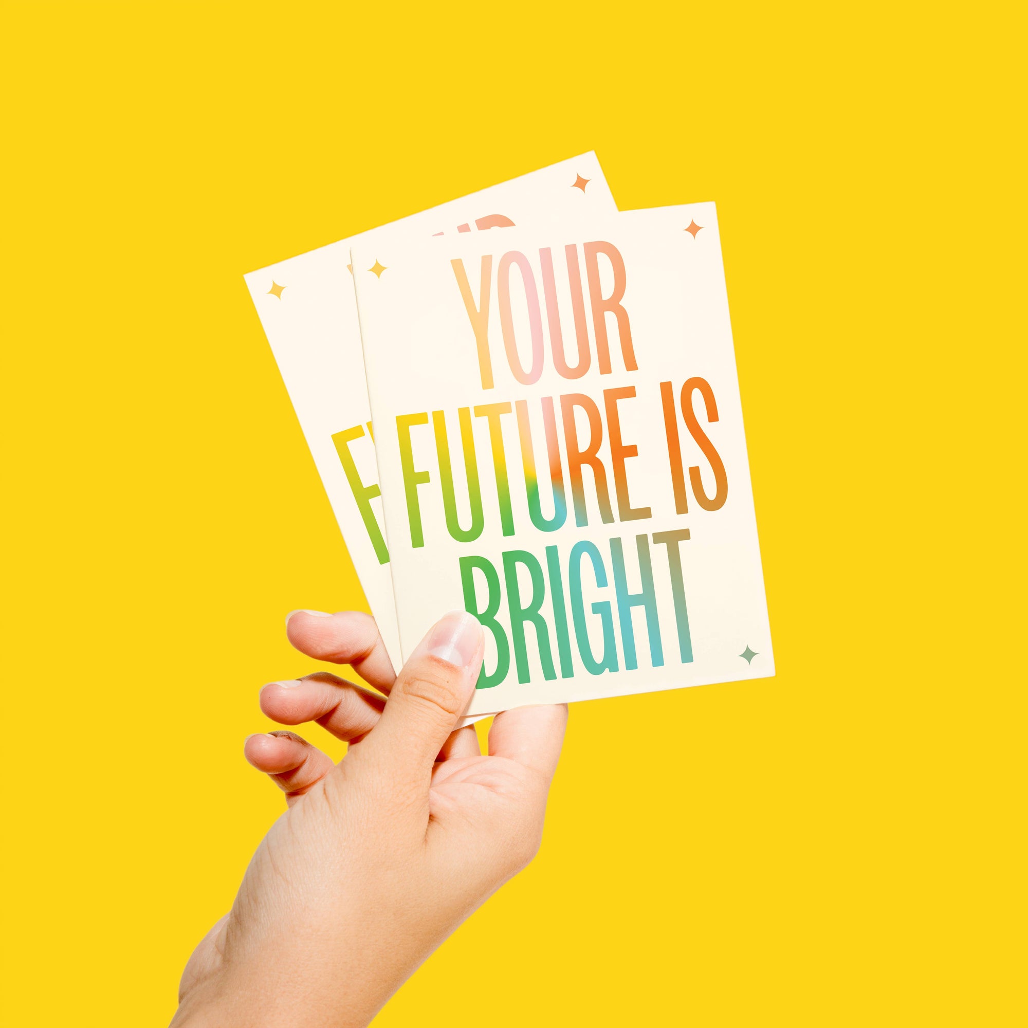 Hand holding a card with 'Your Future is Bright' text on a yellow background
