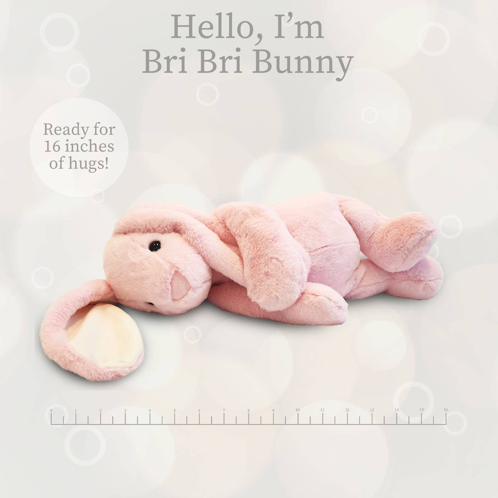 Pink plush bunny toy on a light gray background with text about size and branding.