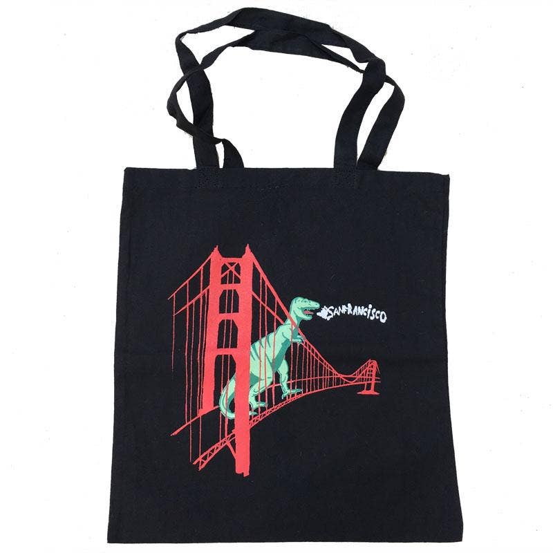 Black tote bag with a graphic of a dinosaur on the Golden Gate Bridge and 'San Francisco' text.