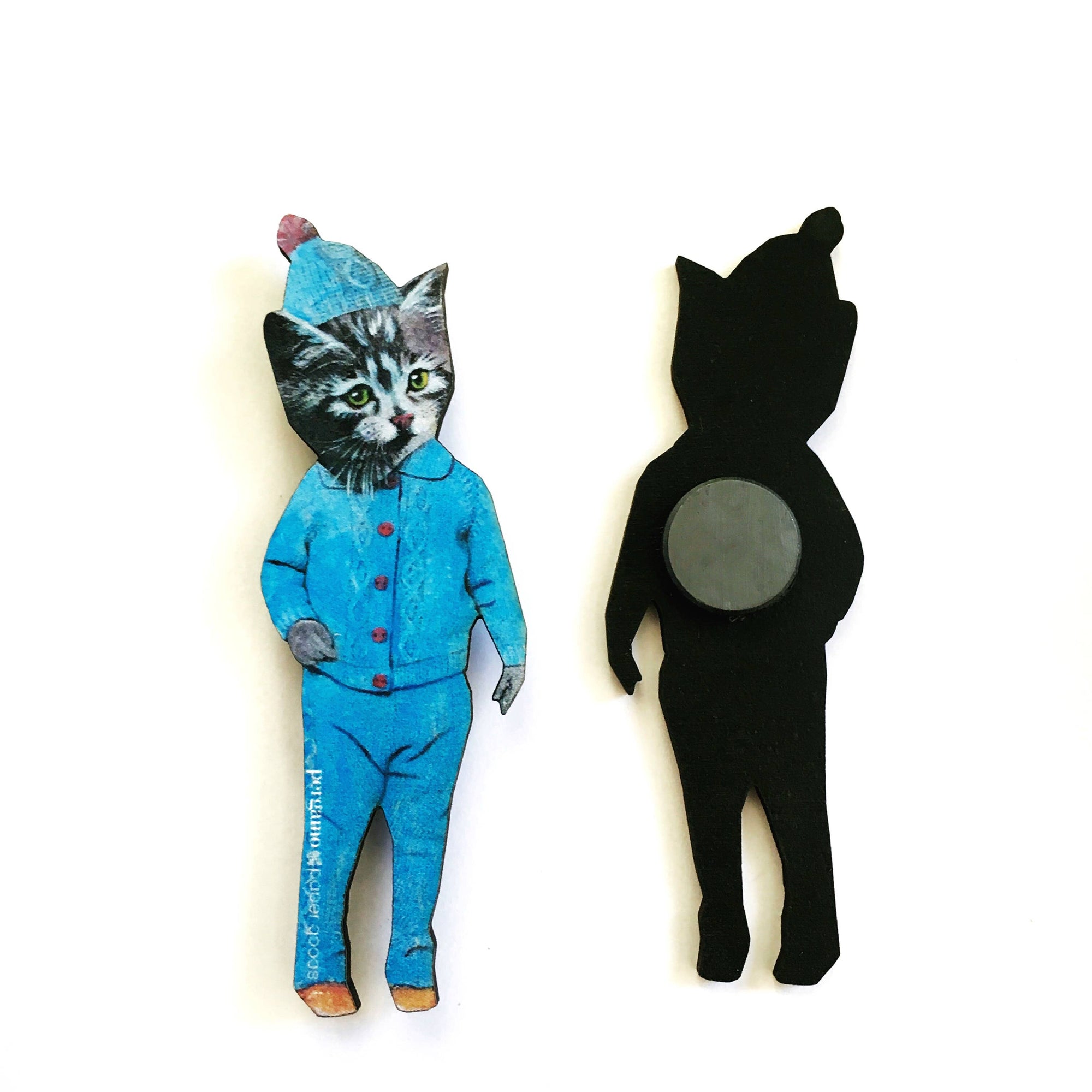 Cat-shaped paper magnet with blue outfit and black silhouette on a white background