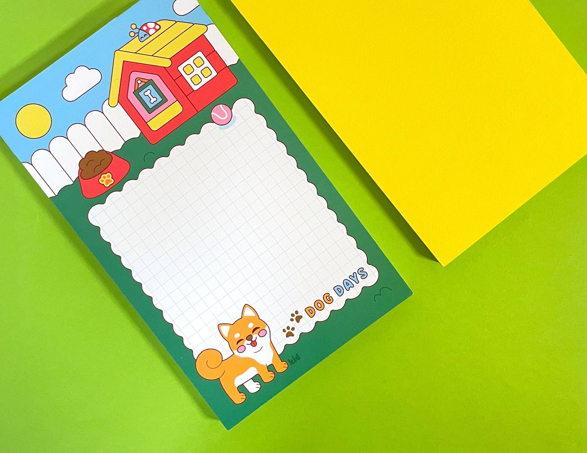Colorful notepad with cartoon designs on a green and yellow background
