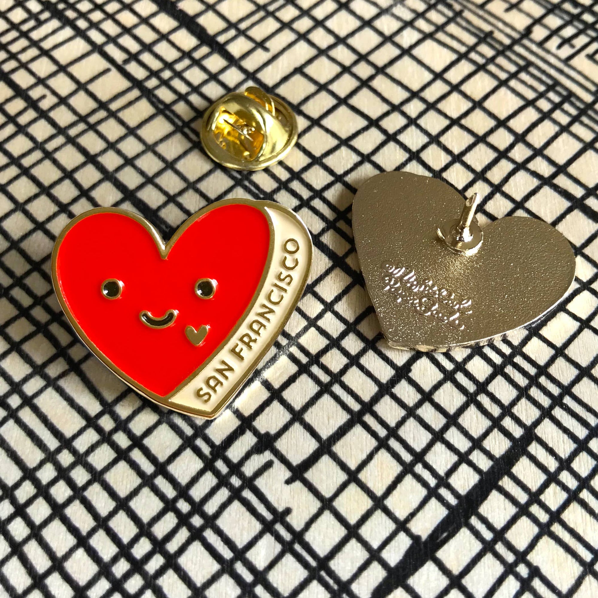 Heart-shaped pins on a checkered background