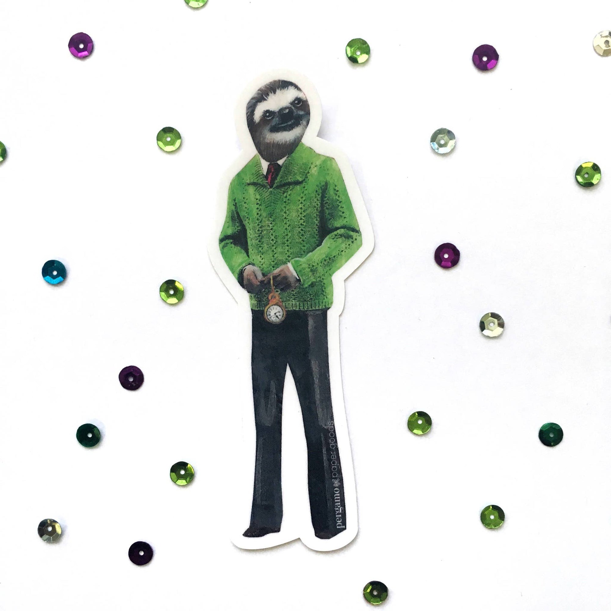 Sticker of a sloth in a green sweater with decorative gems on a white background