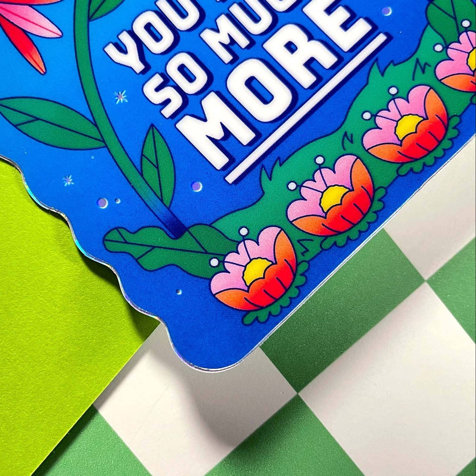 Colorful card with floral design and text on a green and white checkered background