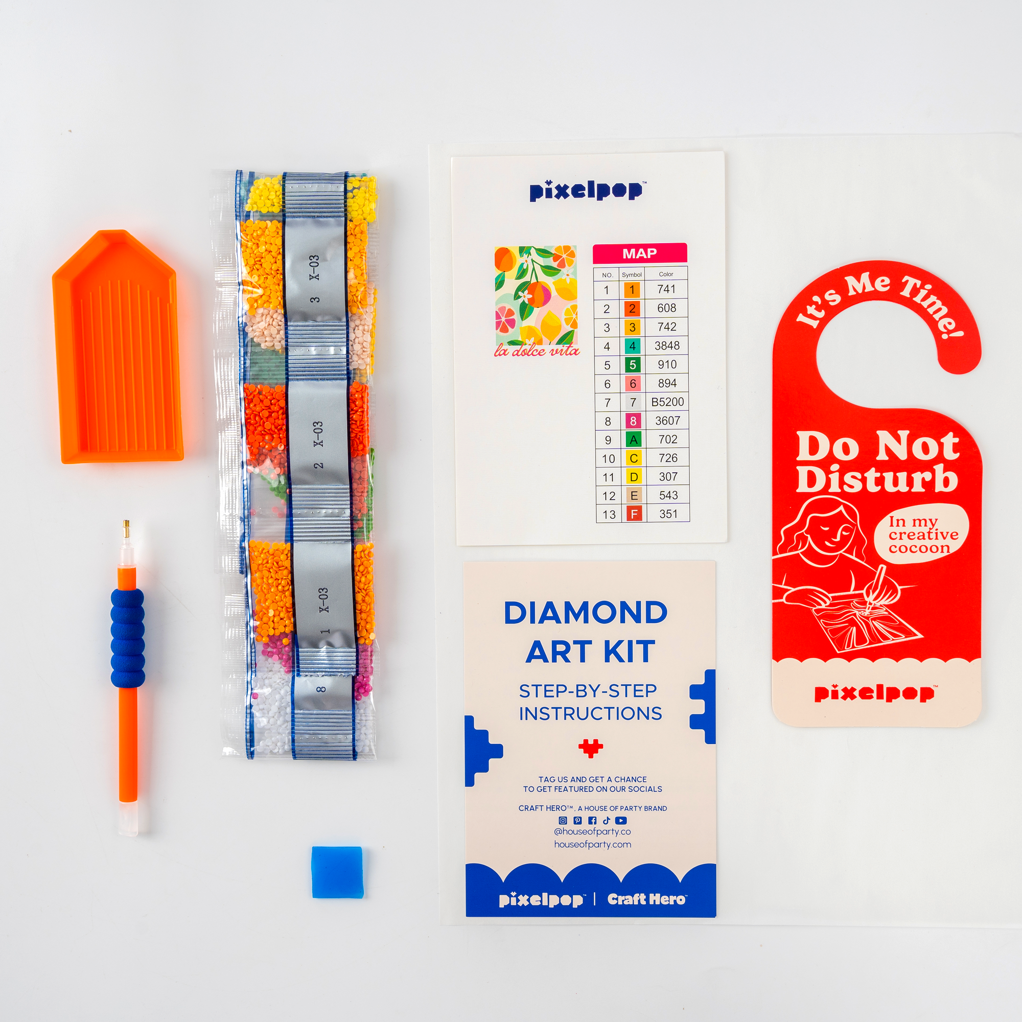 Collection of PixelPop products including a diamond art kit, color swatch, and door hanger on a white background.