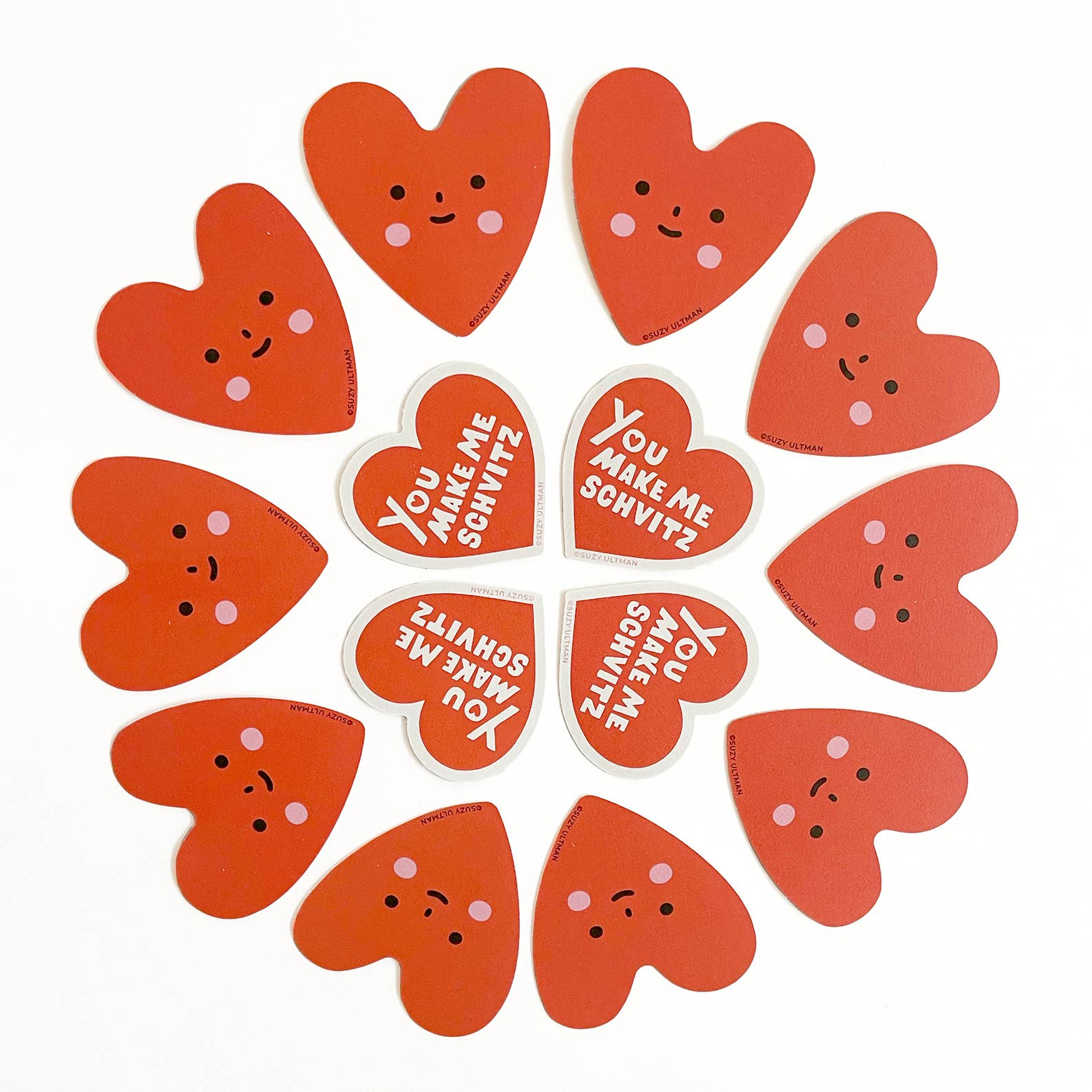 Red heart-shaped stickers with smiling faces and text on a white background