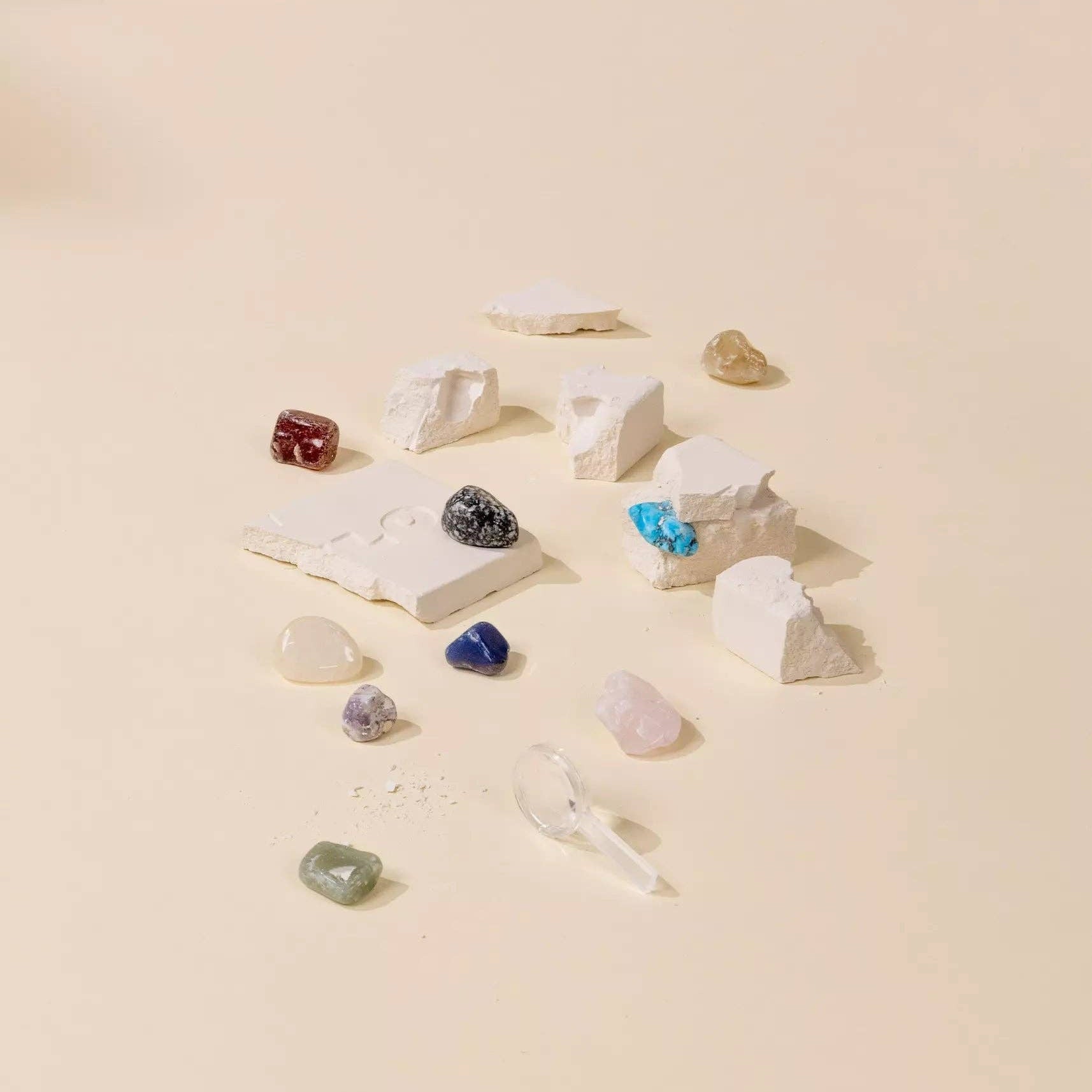 Collection of various stones and crystals on a beige surface