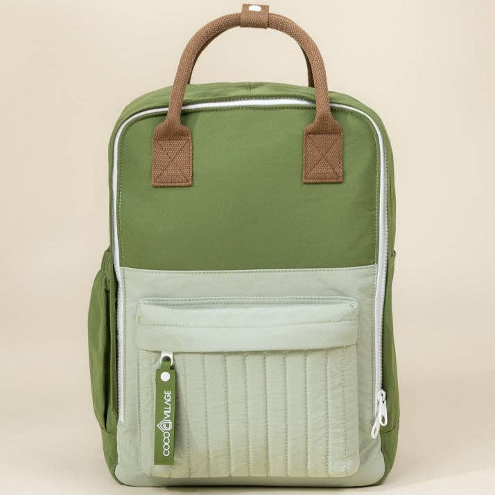 Green backpack with brown straps on a beige background
