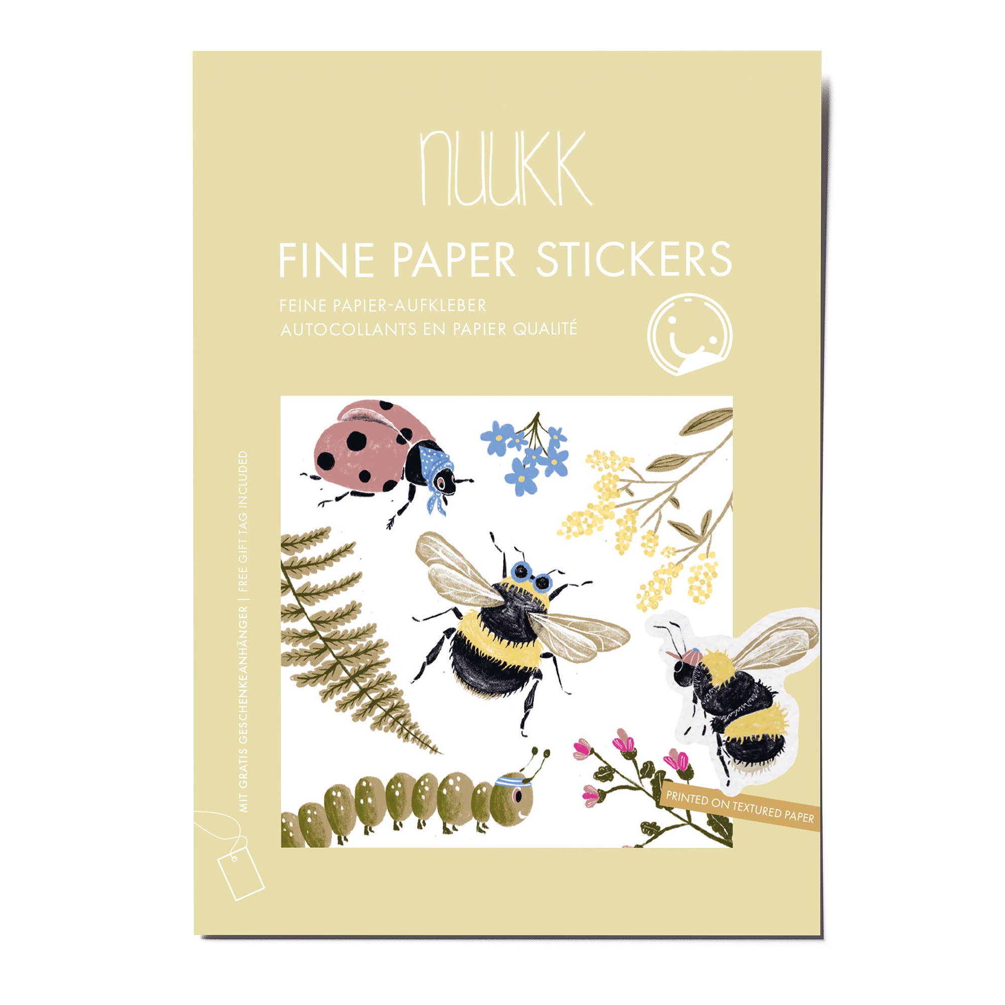 A package of Nuukk Fine Paper Stickers featuring whimsical illustrations of a ladybug, bumblebee, honeybee, fern, caterpillar, and wildflowers on a pale yellow card backing.