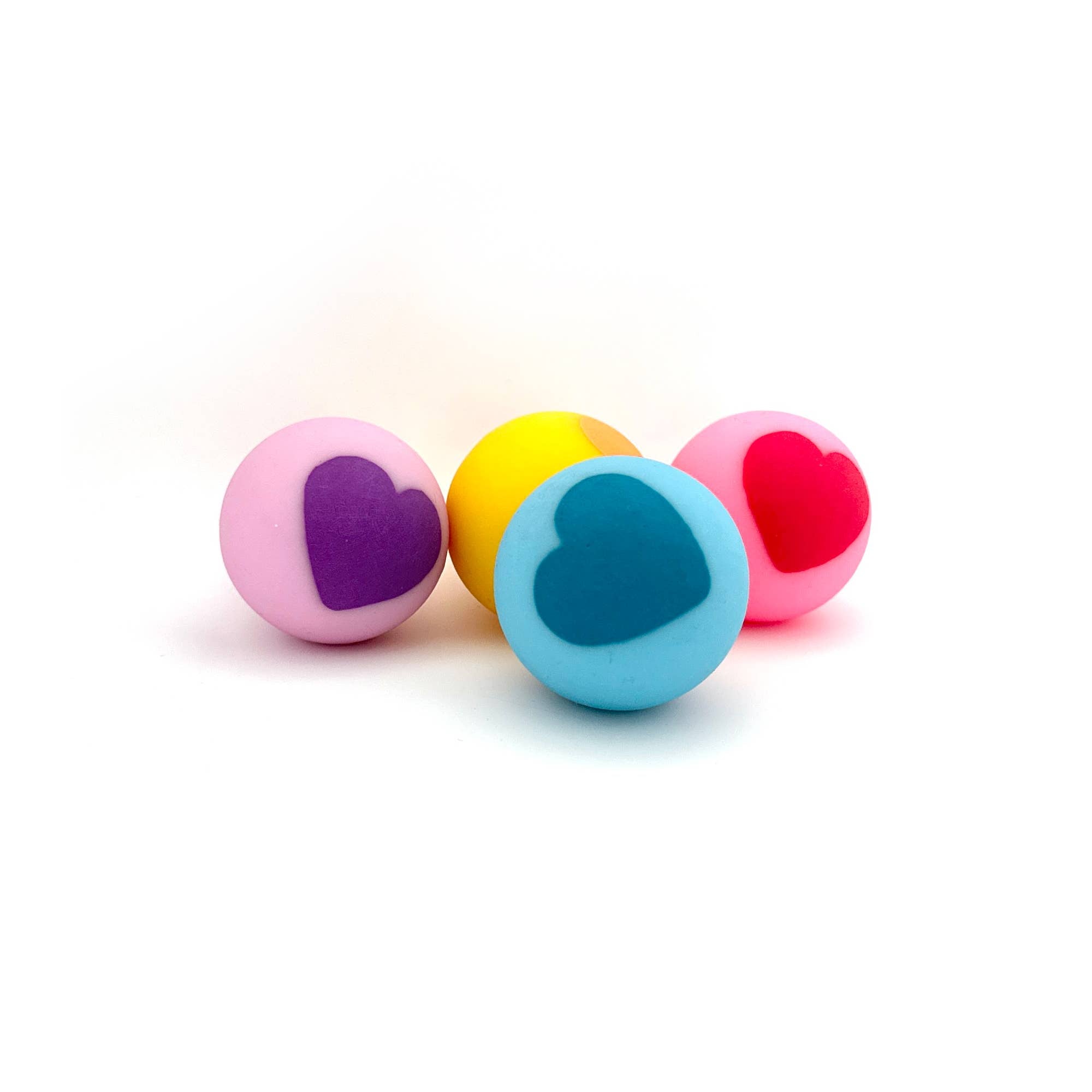 Four colorful heart-shaped balls on a white background