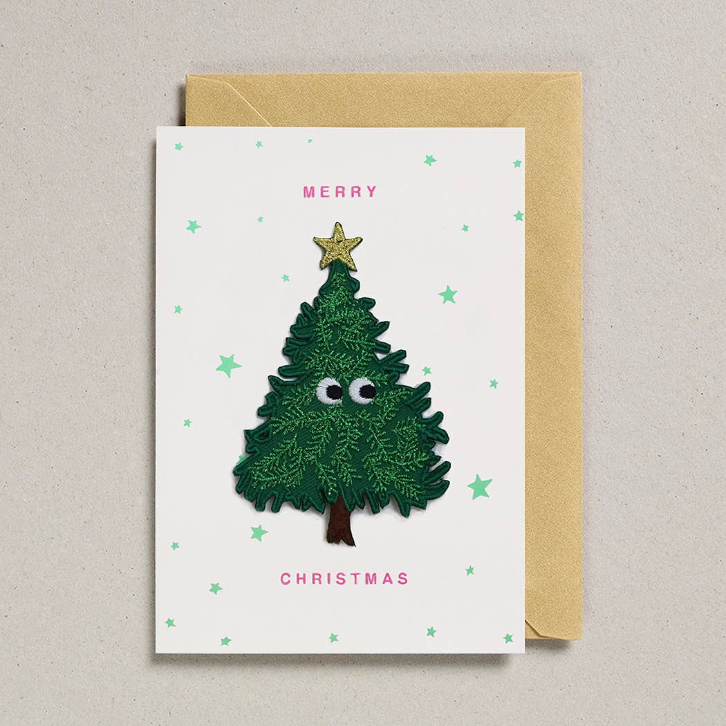 Christmas card with a cartoon Christmas tree, star, and text on a beige background