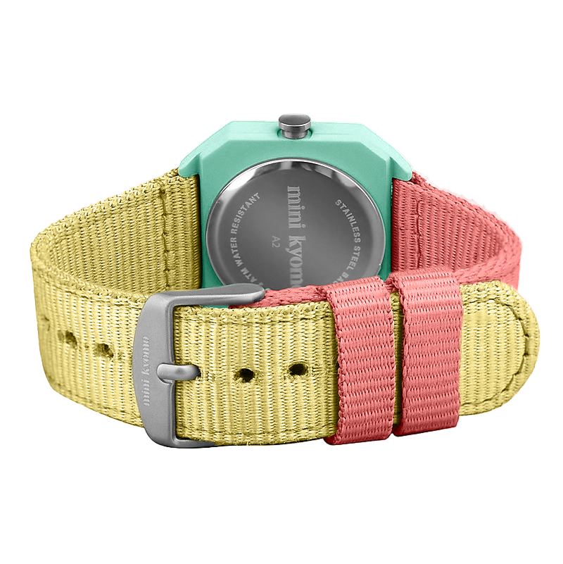 Multicolored watch with a green case and yellow, pink, and red straps on a white background