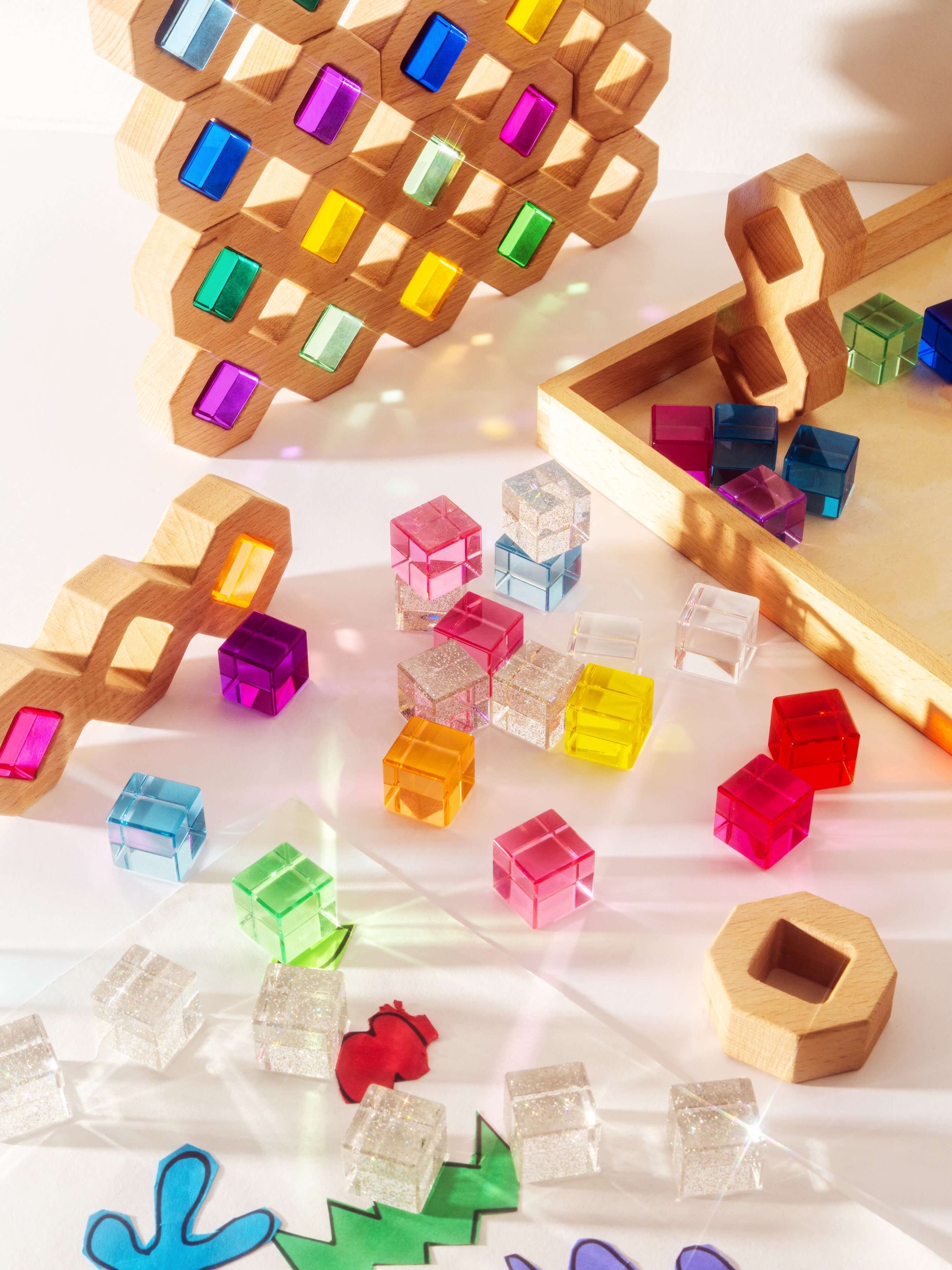 Colorful wooden puzzle pieces on a white surface with wooden frames.