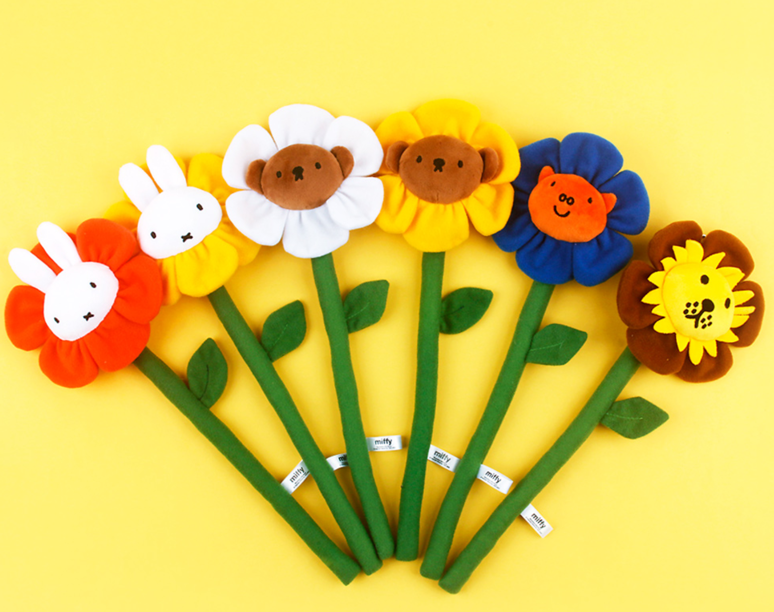 Colorful flower-shaped pens with animal faces on a yellow background