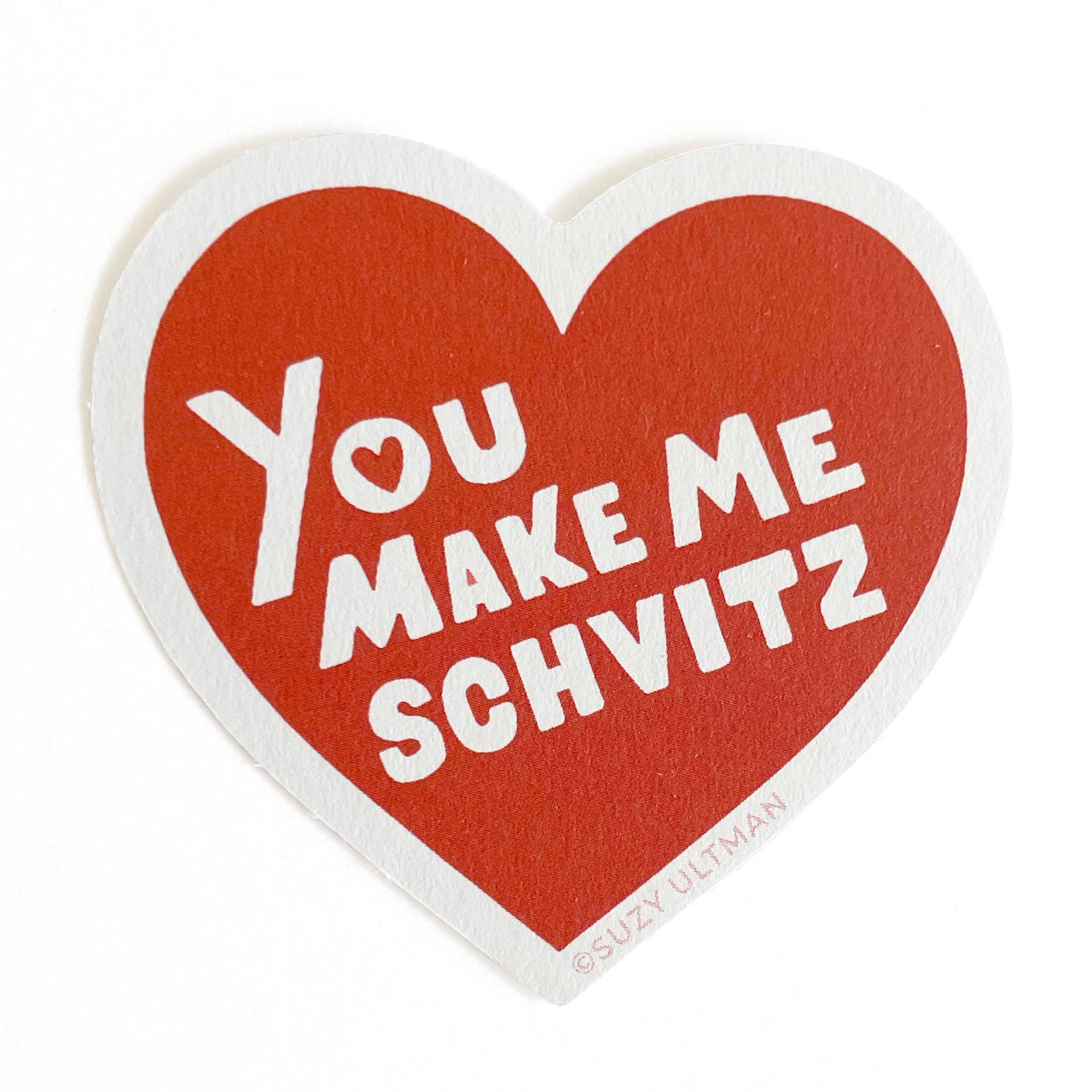 Heart-shaped sticker with text 'You Make Me Schvitz' on a white background