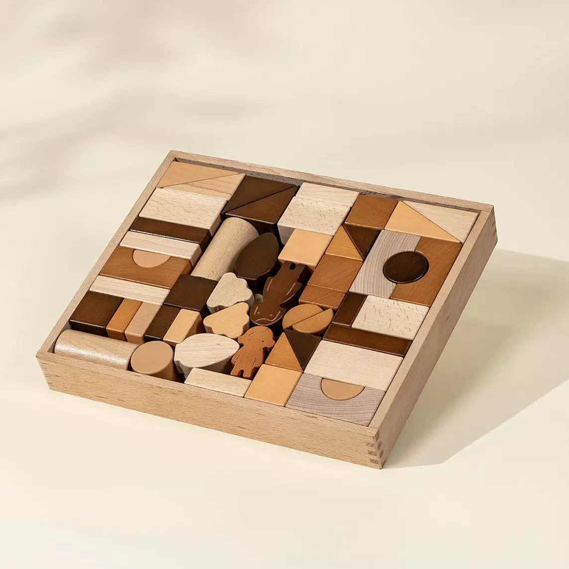 Wooden geometric puzzle in a box on a beige background