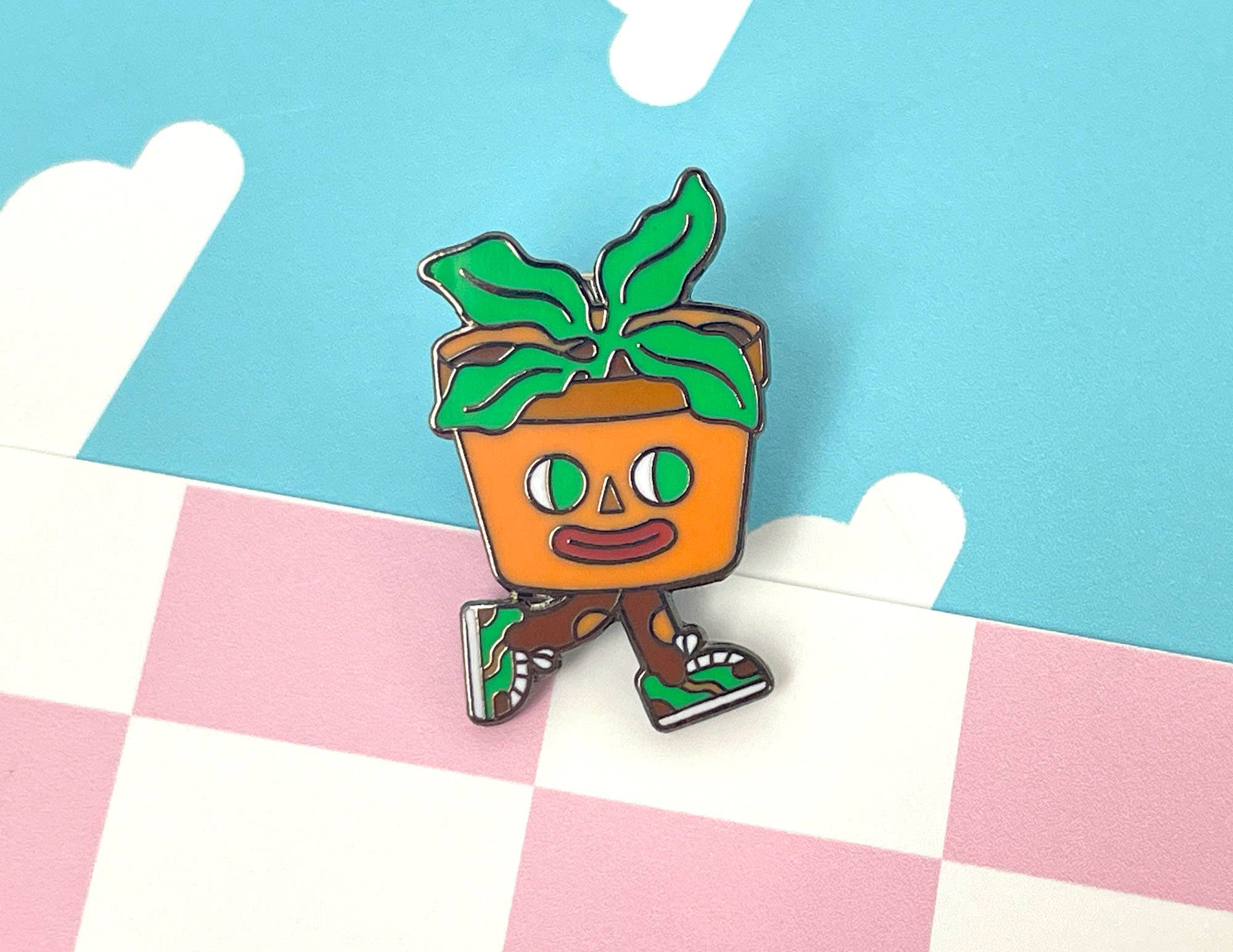 Colorful cartoon-style plant pot character on a checkered background