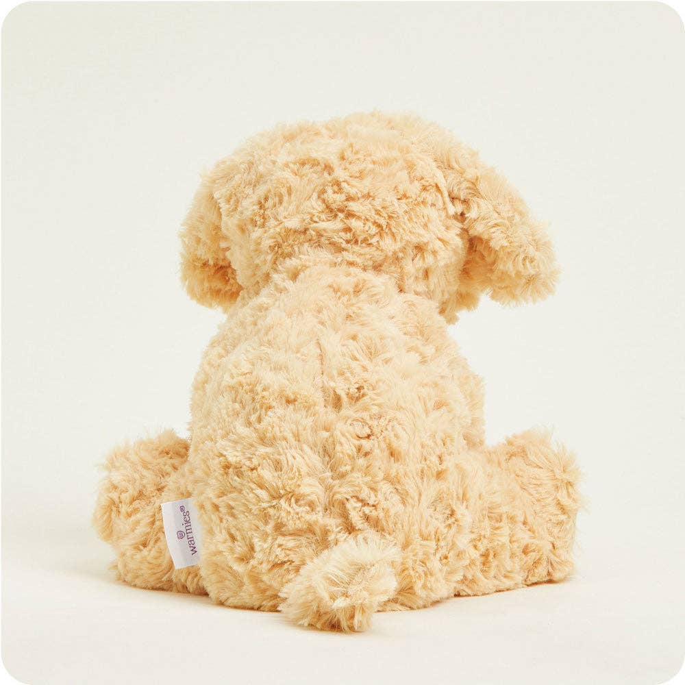 Beige dog with a visible brand label on a white background