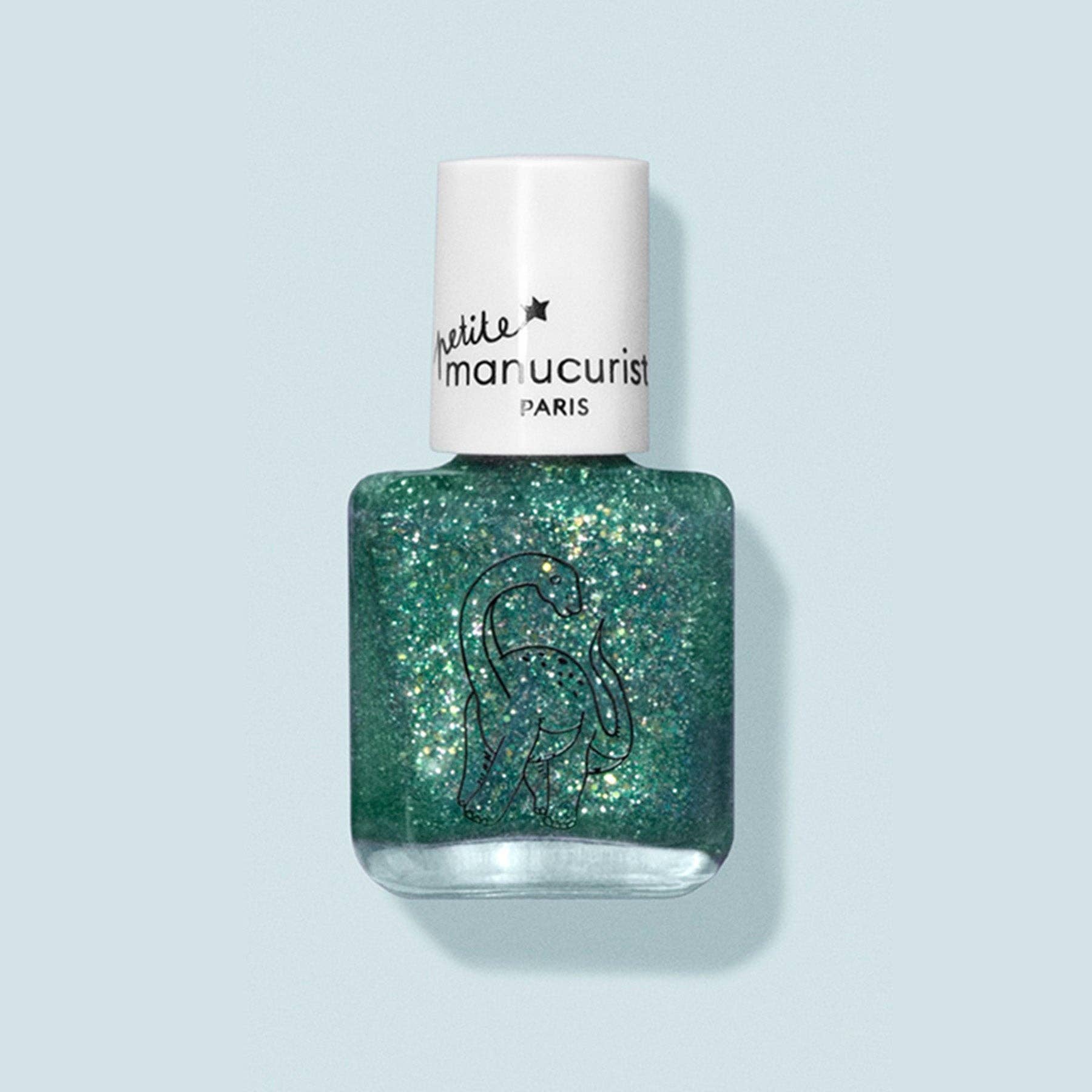 Bottle of glittery green nail polish with a white cap on a light blue background