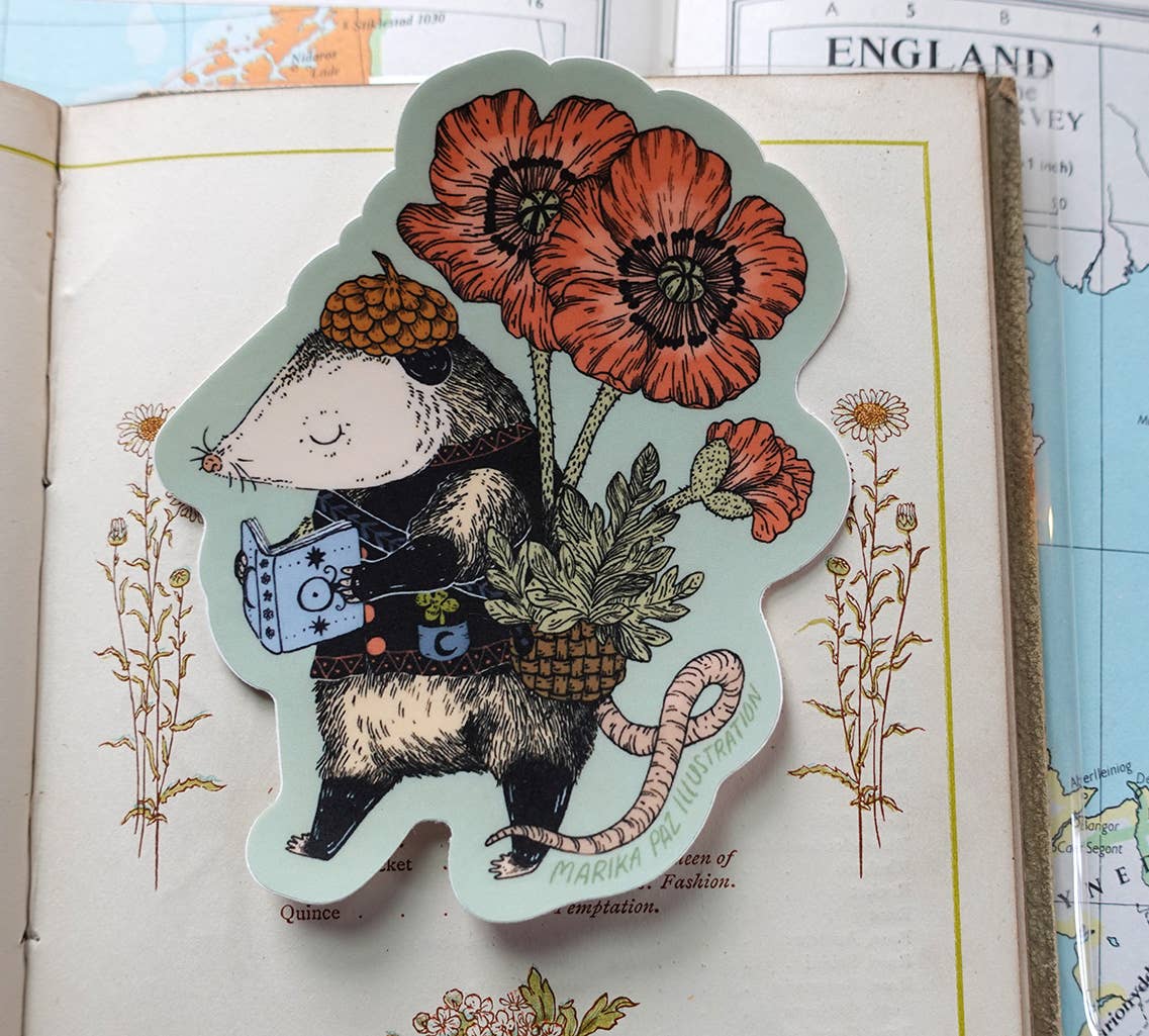 Illustrated sticker of a mouse with flowers on an open book