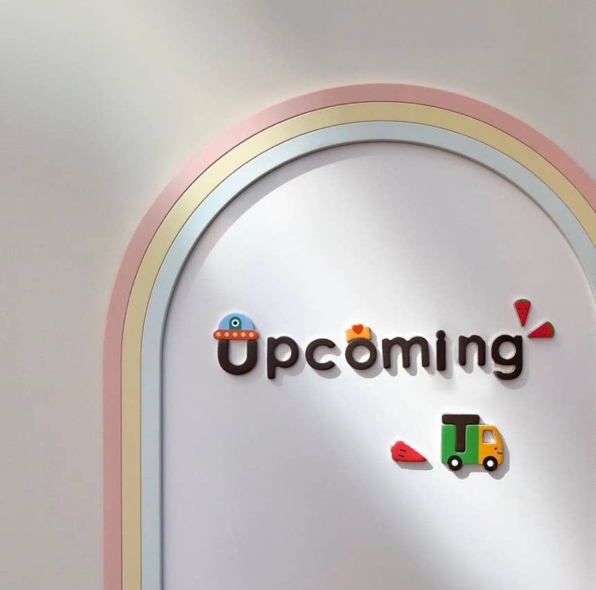 Decorative wall art with 'Upcoming' text and colorful graphics on a light background