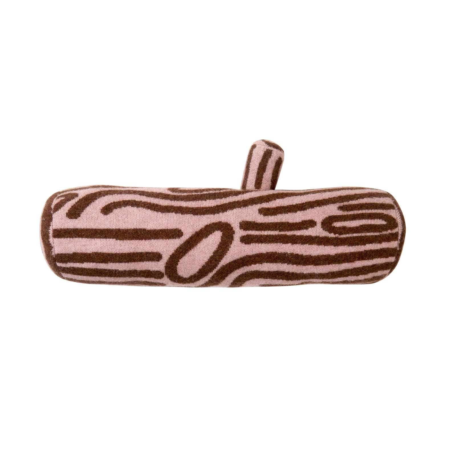 A plush cylindrical pillow designed to look like a tree trunk, featuring a light pink background with dark brown wood grain patterns and a small matching fabric loop on top, set against a plain white background.