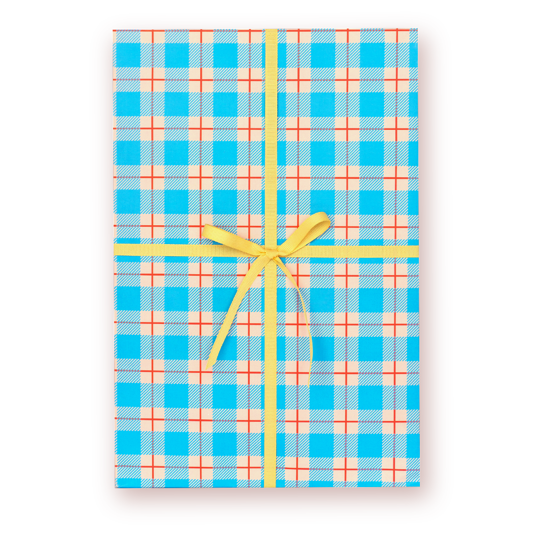 Plaid gift wrap with a yellow ribbon on a white background