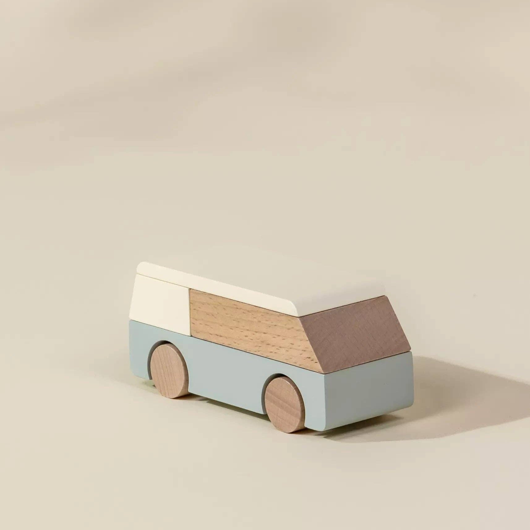 Wooden toy van on a beige background