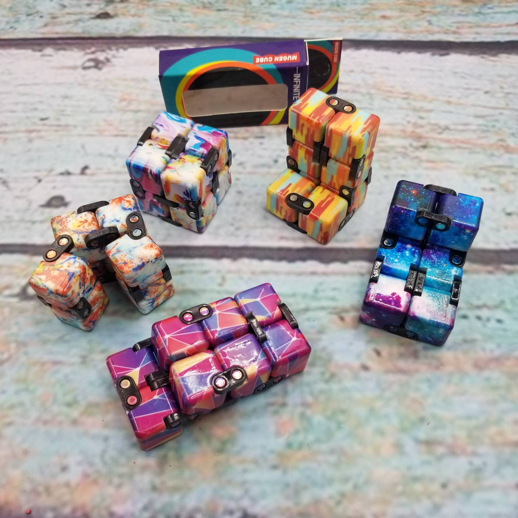 Colorful fidget cube toys on a wooden surface