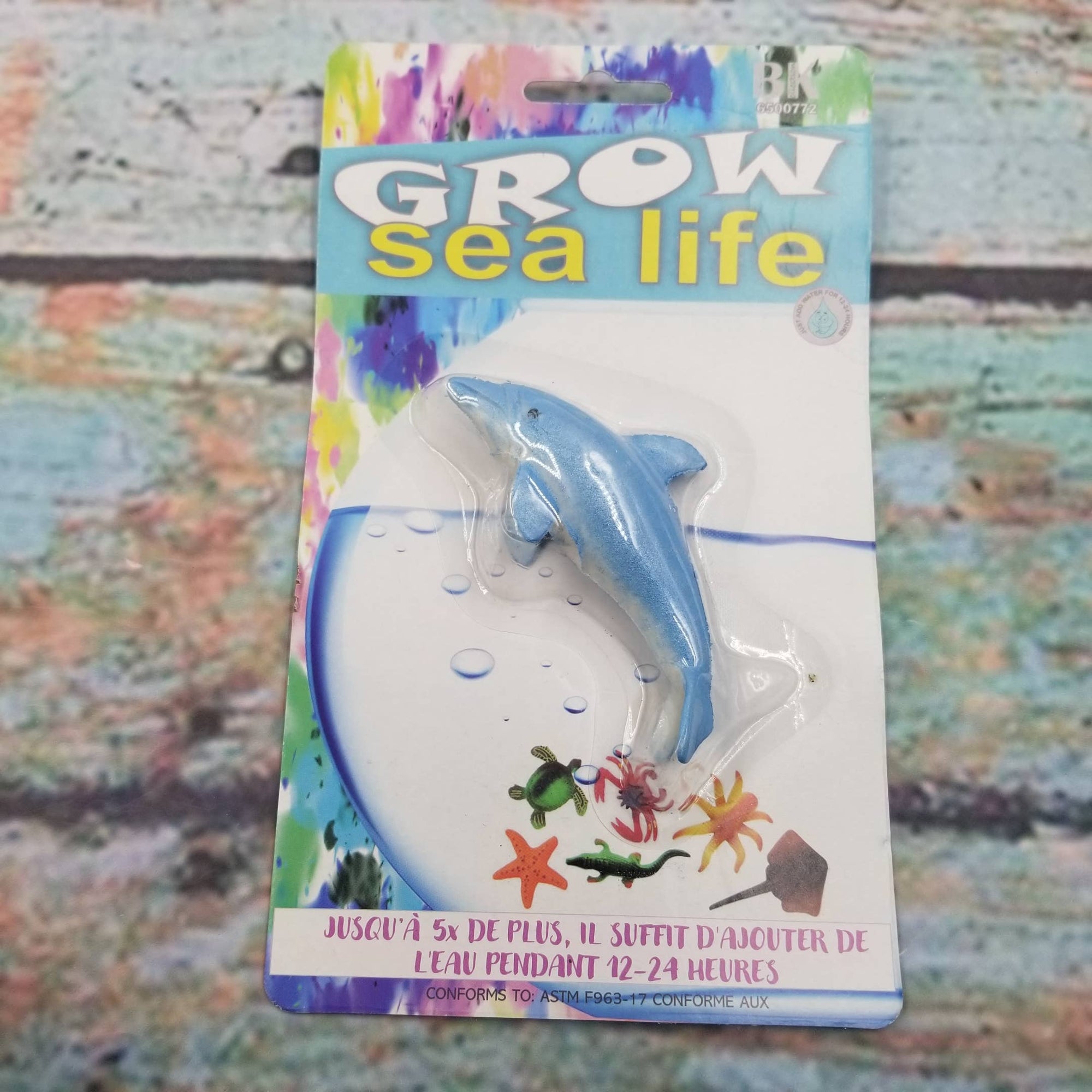 Grow sea life toy packaging with a dolphin figure on a colorful background