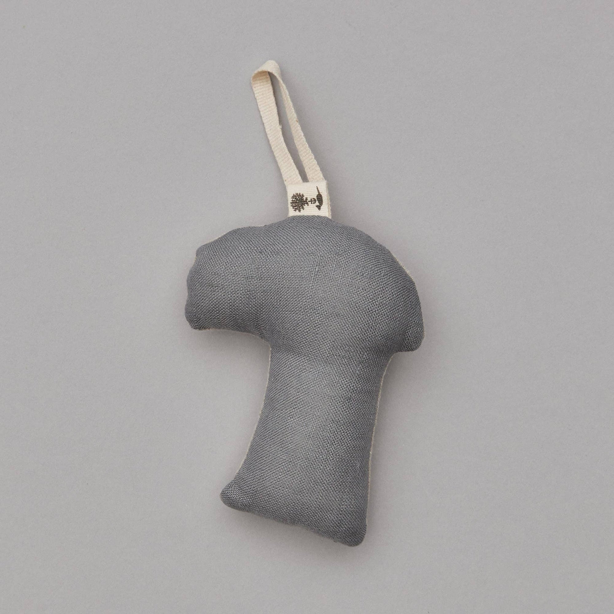 Gray fabric ornament with a handle on a gray background