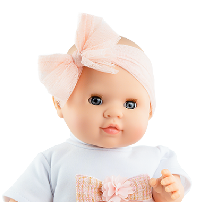 Baby doll wearing a pink dress with a bow and headband on a white background
