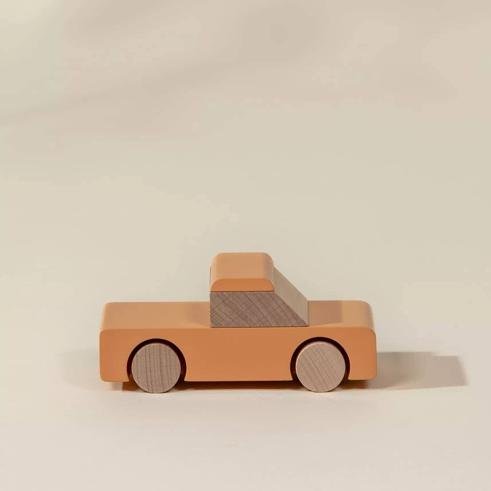 Wooden toy truck on a beige background