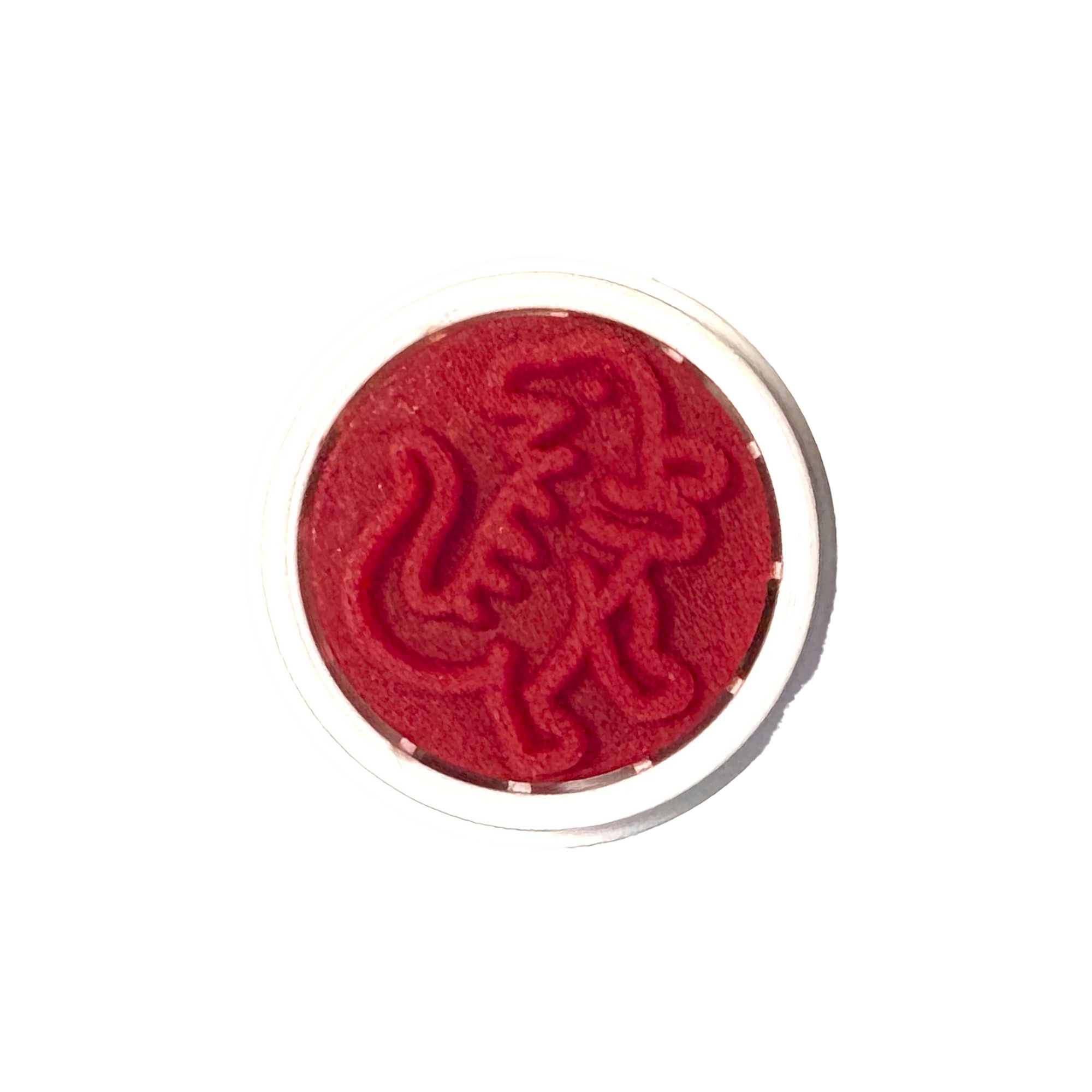 Red circular object with a design on a white background
