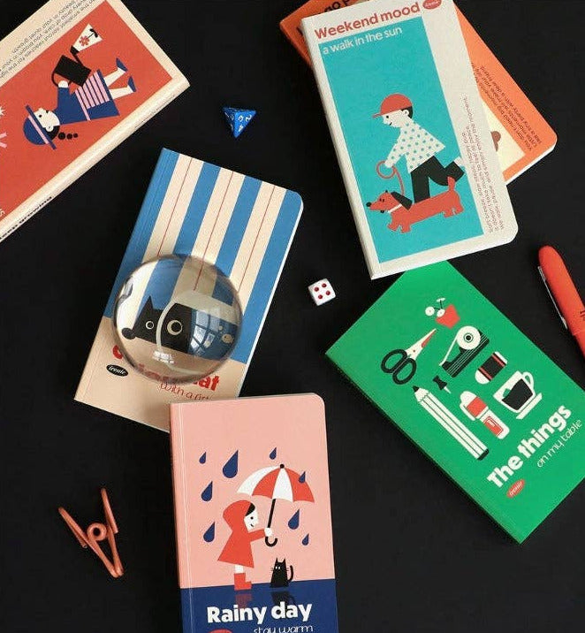 Collection of small notebooks with colorful covers on a black background